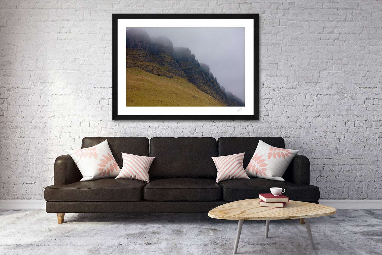 a framed fine art photograph of a close up view of Sligo's famous Benbulben Mountain, highlighting it's curves and gullies on an overcast day hung on a white painted brick wall over a brown sofa and coffee table