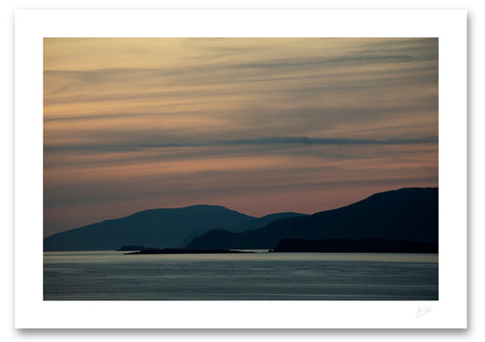 an unframed print of Clare and Achill Islands silhouetted in front of a palette of twilight colour, avalable to buy online