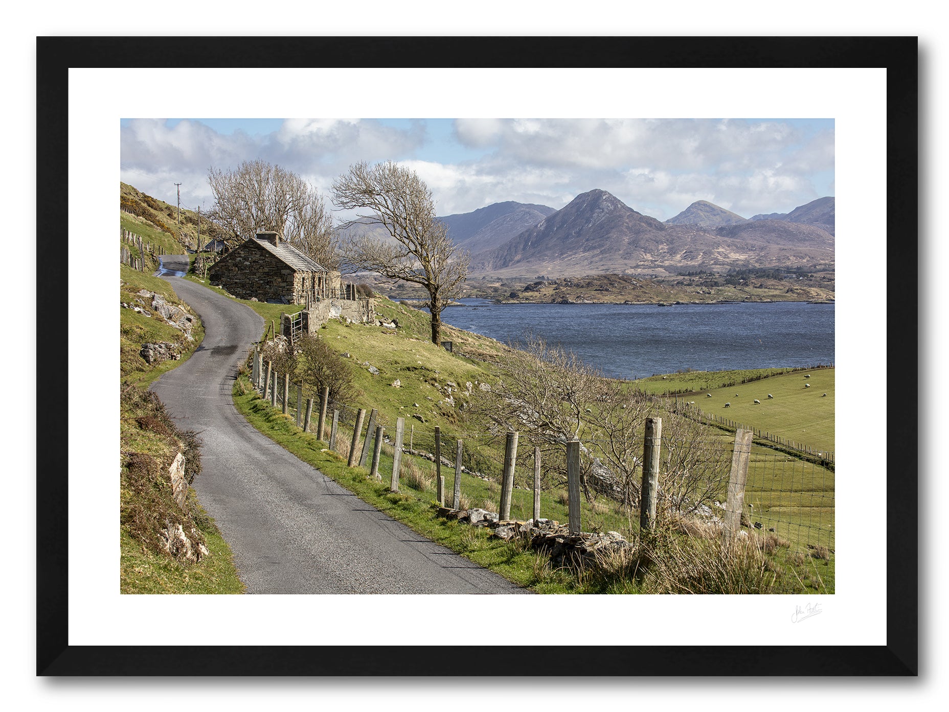 a framed fine art photographic print of Connemara from Derryinver on the Renvyle Peninsula with its rugged landscape, sea, inlets and islets, and the 12 Bens mountain range, available to buy online