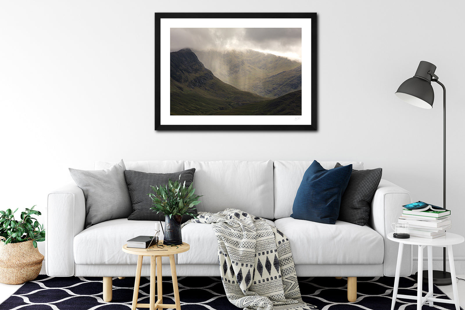 a framed fine art photograph of a rain shower on the peak of Ben Gorm mountain in Mayo, hanging on a wall above a white sofa
