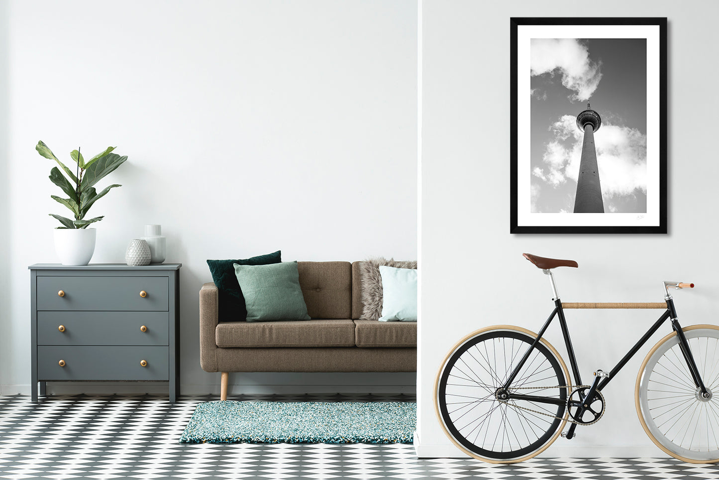 a framed fine art photographic print of Berlin's famous TV tower from below, hanging on a living room wall