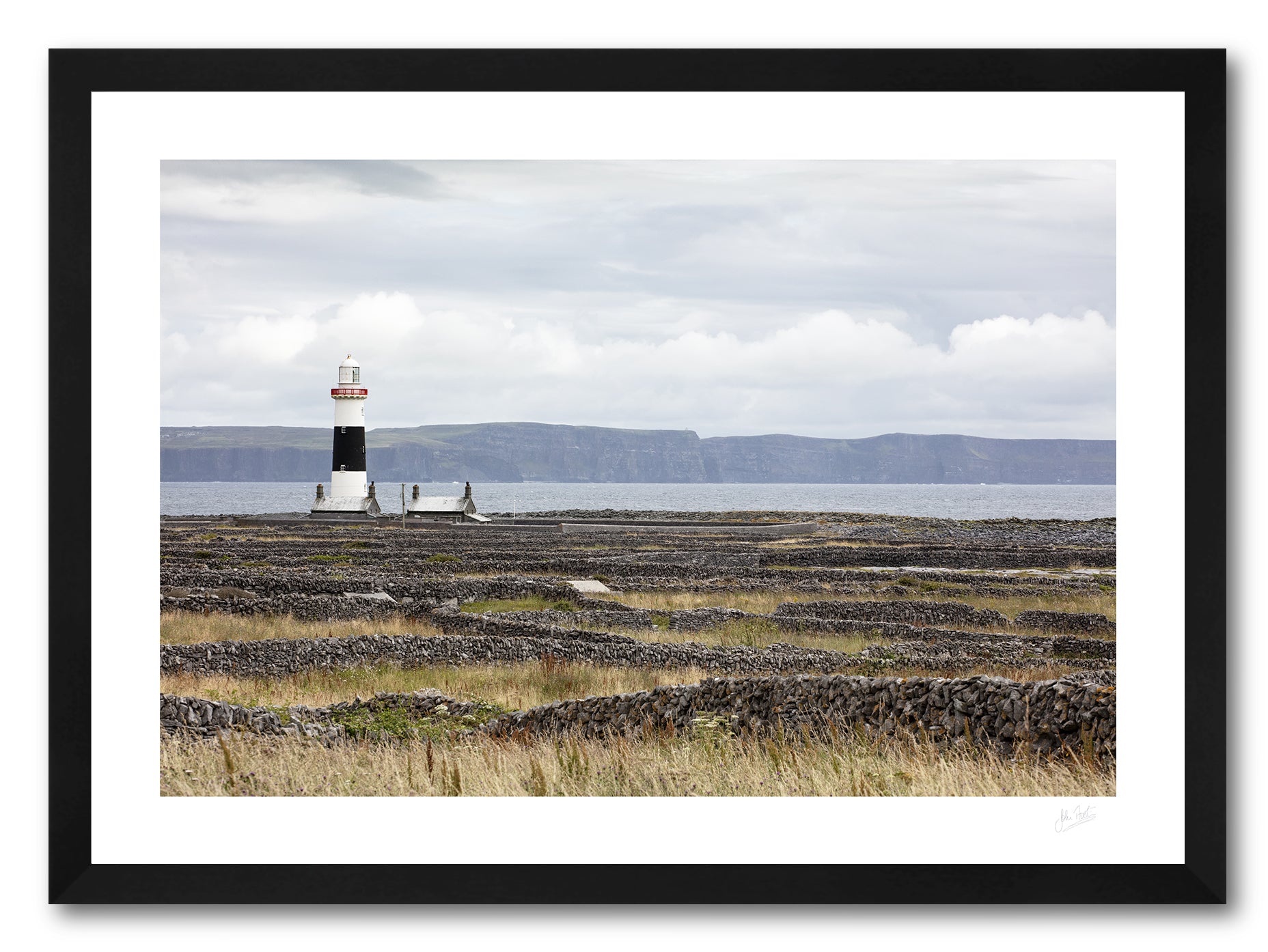 a framed fine art photographic print of Inisheer Island's famous dry stone walls surrounding the lighthouse while the Cliffs of Moher are visible in the background, available to buy online