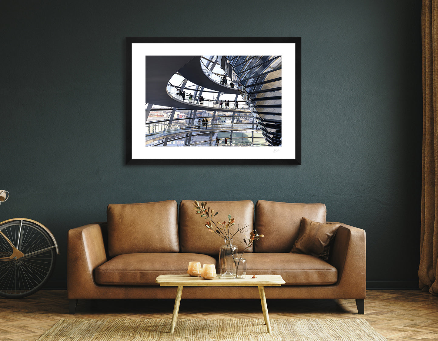 a framed fine art photographic print of the inside of the Reichstag Dome in Berlin, Germany with visitors looking out at the city skyline, hanging on a wall above a brown sofa
