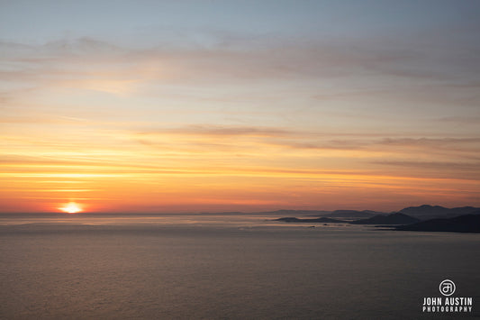 summer sunrise across Sheephaven Bay in Donegal with a silhoutetted coastline