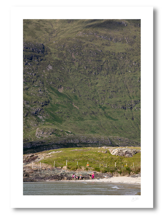 a fine art photogrphic print of friends catching up on a lovely summer afternoon on Glassilaun Beach, Connemara, Ireland with the large Mweelrea mountain as the background.