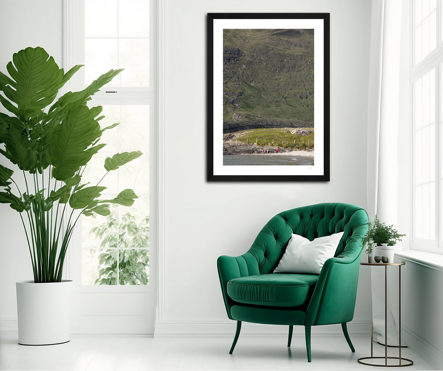 a framed fine art photogrphic print of friends catching up on a lovely summer afternoon on Glassilaun Beach, Connemara, Ireland with the large Mweelrea mountain as the background hanging on  white wall above a green chair 