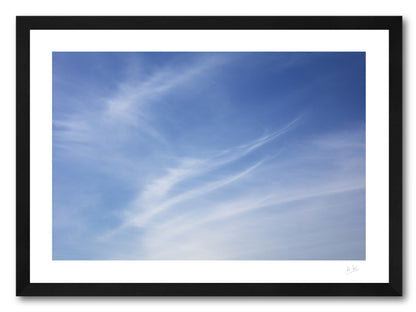 a framed fine art photographic print of feather shaped cirrus clouds over Dooey Beach in Donegal on a summer evening