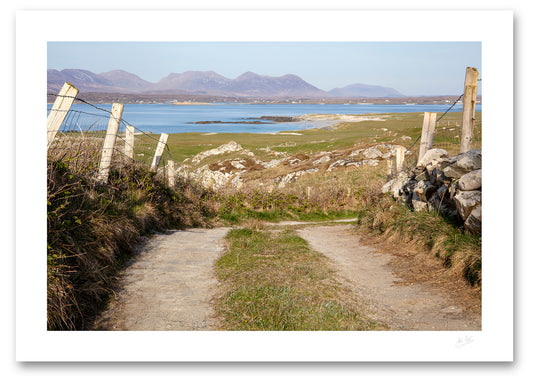 a fine art photograph of the view from a narrow country road in Mannin Beg, Connemara looking across Mannin Bay at the 12 Bens mountain range