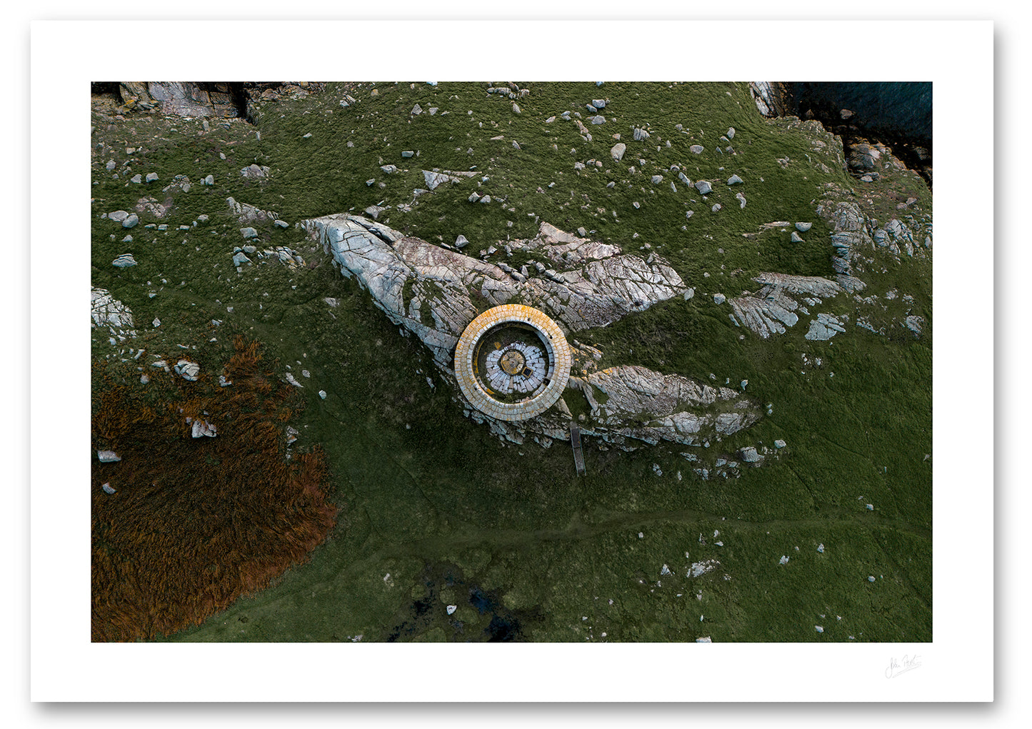 an aerial view of the Martello Tower on Dalkey Island where this perspective shows that the distinction between man-made and natural disappears, as the stone tower made of the same granite rock emerges to become one