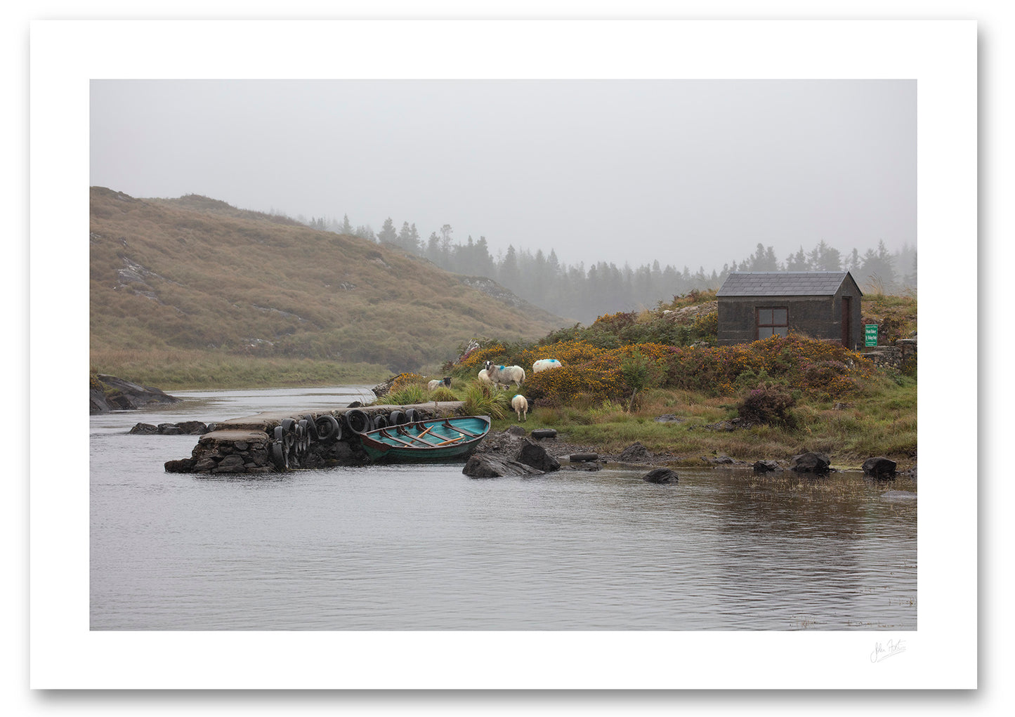 a fine art photograph of a fishing hut and row boat mooring on the Owenmore River on a rainy day with a few grazing sheep