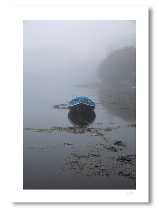scene in the coastal fishing town of Roundstone, Connemara, with a boat and harbour shrouded in a dense fog