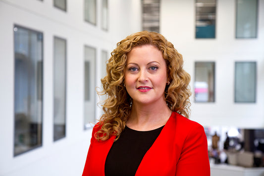 headshot portrait of a red head woman in an office building