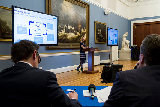 a young woman making a presentation between two judges at the Royal Dublin Society