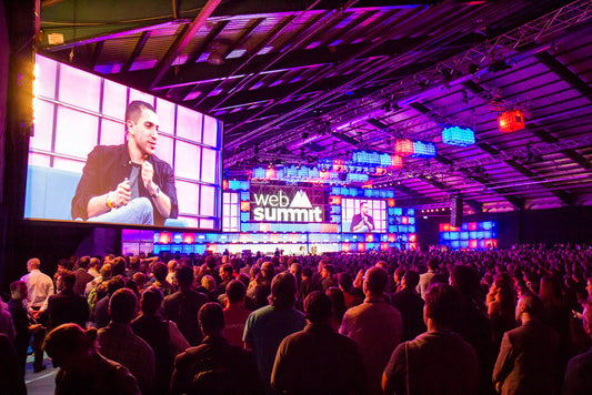 a large audience focuses on a main stage presentation at the Web Summit in the RDS