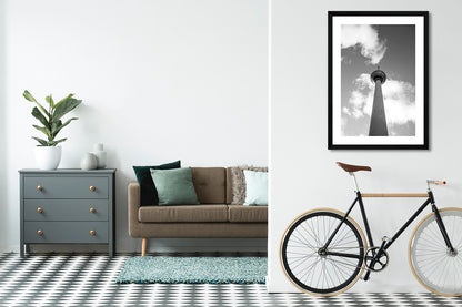 a framed fine art photographic print of Berlin's famous TV tower from below,  hanging on a living room wall