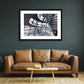 a framed fine art photographic print of the inside of the Reichstag Dome in Berlin, Germany with visitors looking out at the city skyline, hanging on a wall above a brown sofa