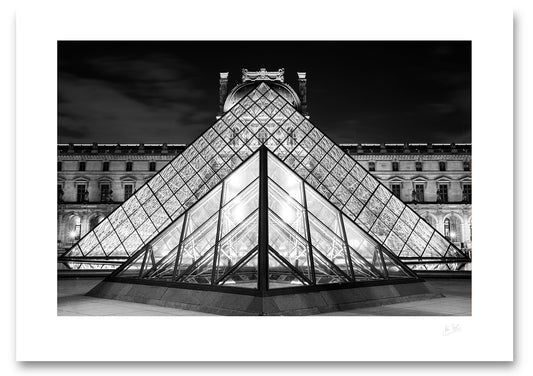 unframed black and white fine art print of the pyramids at the side entrance to the Louvre Museum lined up in perfect symmetry
