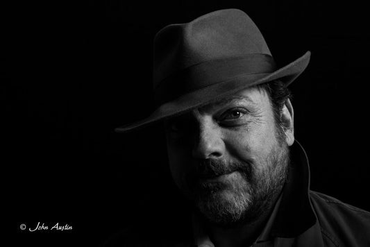 black and white portait of Hugh wearing his favourite hat