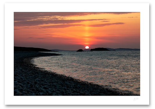 unframed fine art print of the sun setting over Inishboffin Island from a silhouetted stoney Ross Beach in Connemara