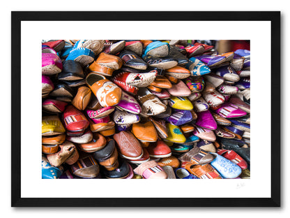 a framed fine art photographic print of a pile of different coloured shoes for sale in a leather shop in Tangier, Morocco, available to buy online