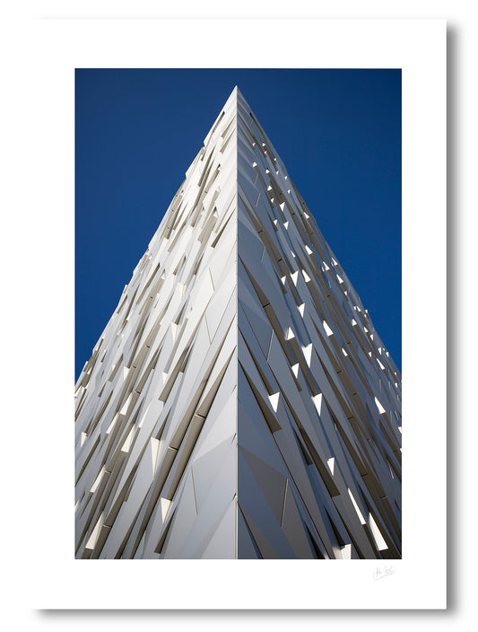 unframed fine art print of the hull shaped outside of the Titanic Eperience in Belfast against a blue sky